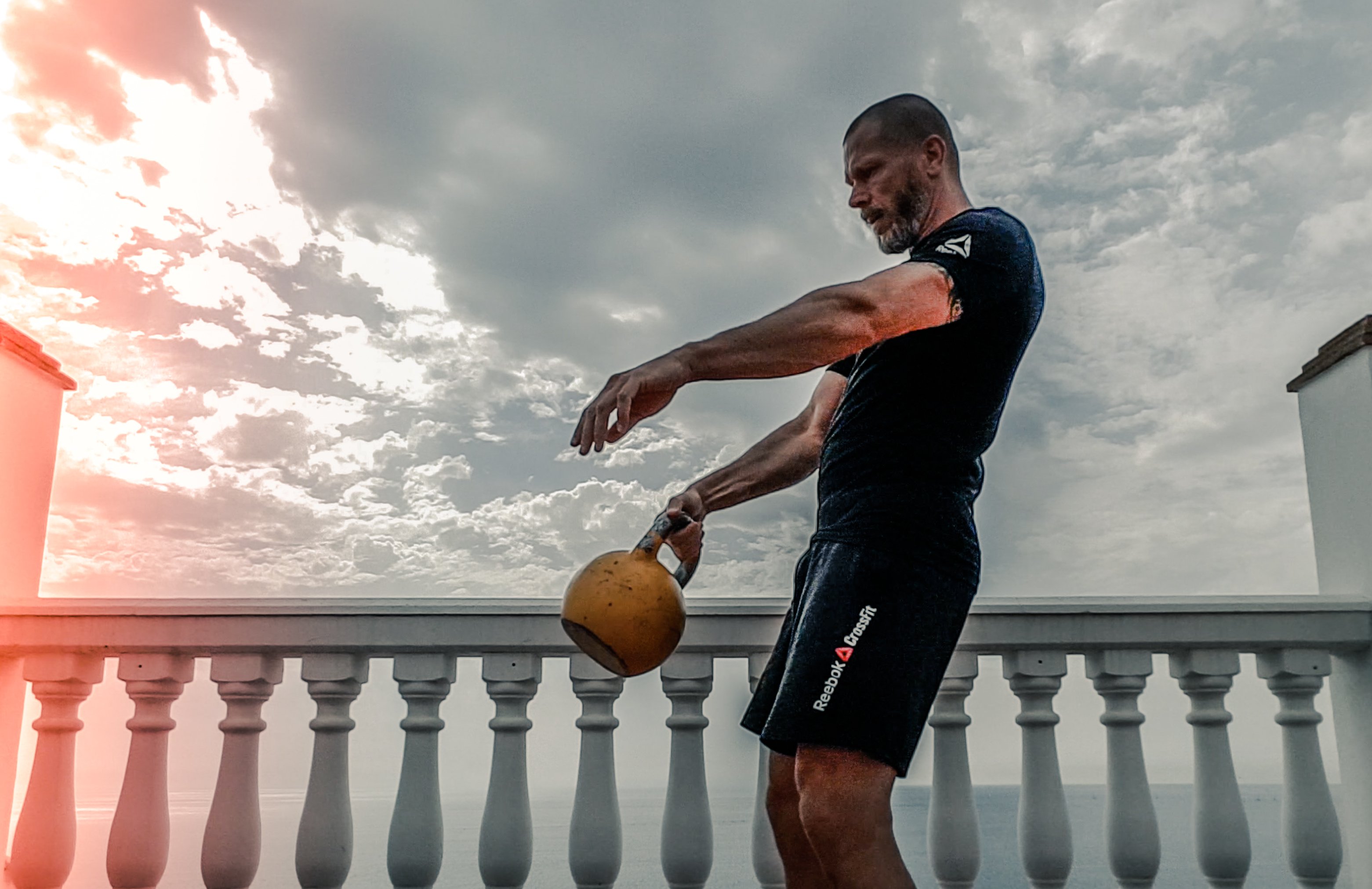 Canva - Man in Black Shirt Carrying Kettle Bell Outdoors